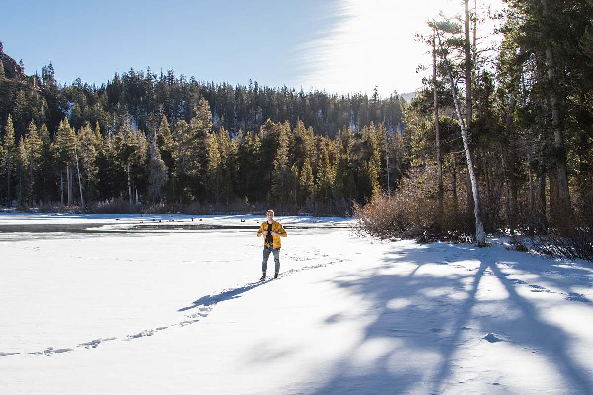 mammoth lakes man walking in snow plain near forest male